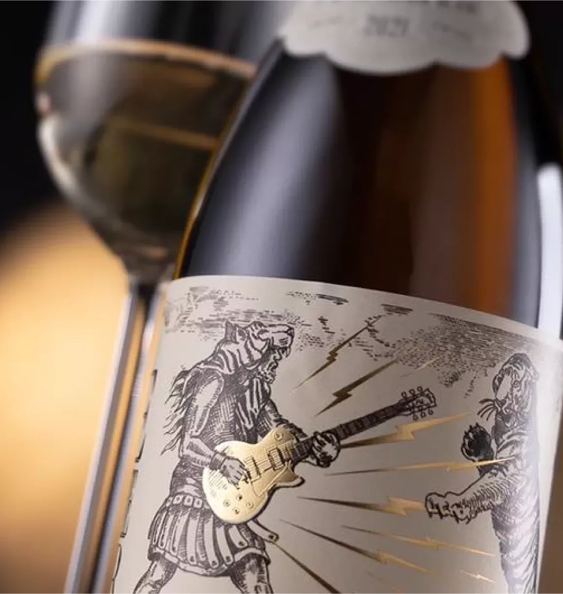 Close-up of Le Béton Cinsault ‘Eye of the Tiger’ wine label showing man playing guitar to a tiger in a battle-like scene